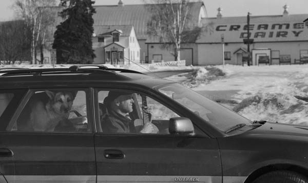 Tim Robb practices guitar while his dog hangs out at Creamers Field, April 2012.
