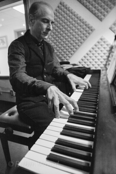 Bruce Adolphe, host of Piano Puzzler, warms up before playing for conetestants.