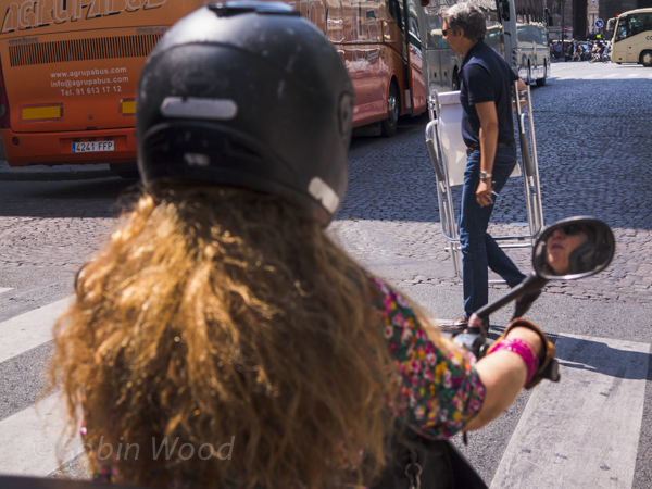 Mopeds, pedestrians and tour busses. 