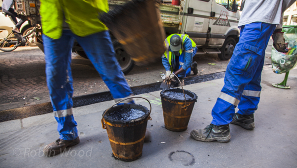 Using old wooden buckets to transport tar