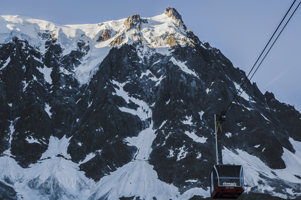 The Aguille de Midi cable car quickly becomes obscured by the mountain it will soon summit. 