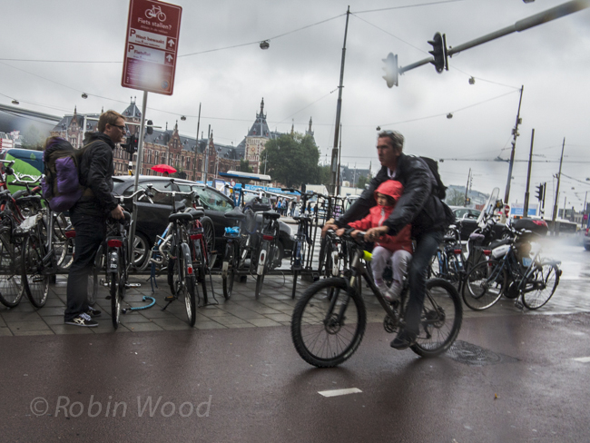 Baby on bike with rain and blur. 