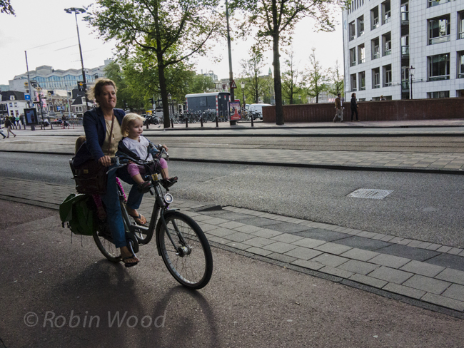 Kids on bikes in precarious positions are commonplace in Amsterdam. 