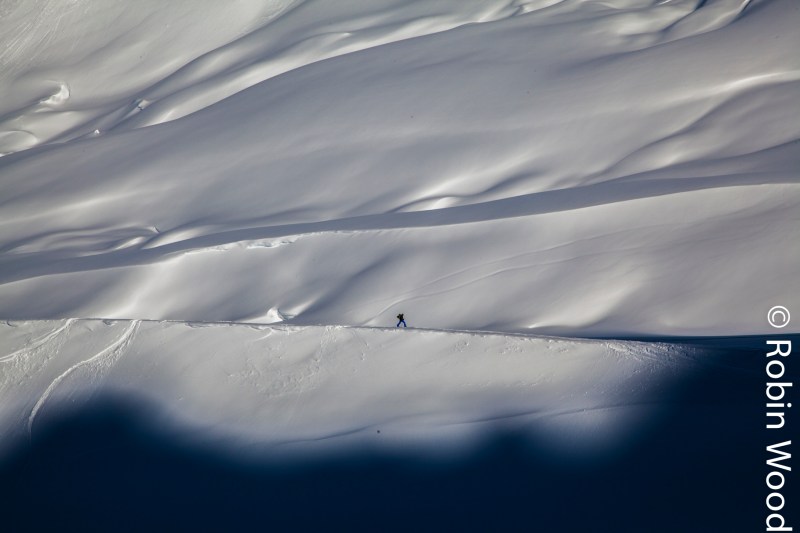 A skier traverses towards shade on the Diamond Glacier in Thompson Pass.